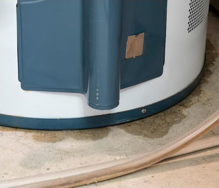 a blue and white hot water heater showing signs of a water leak ” 